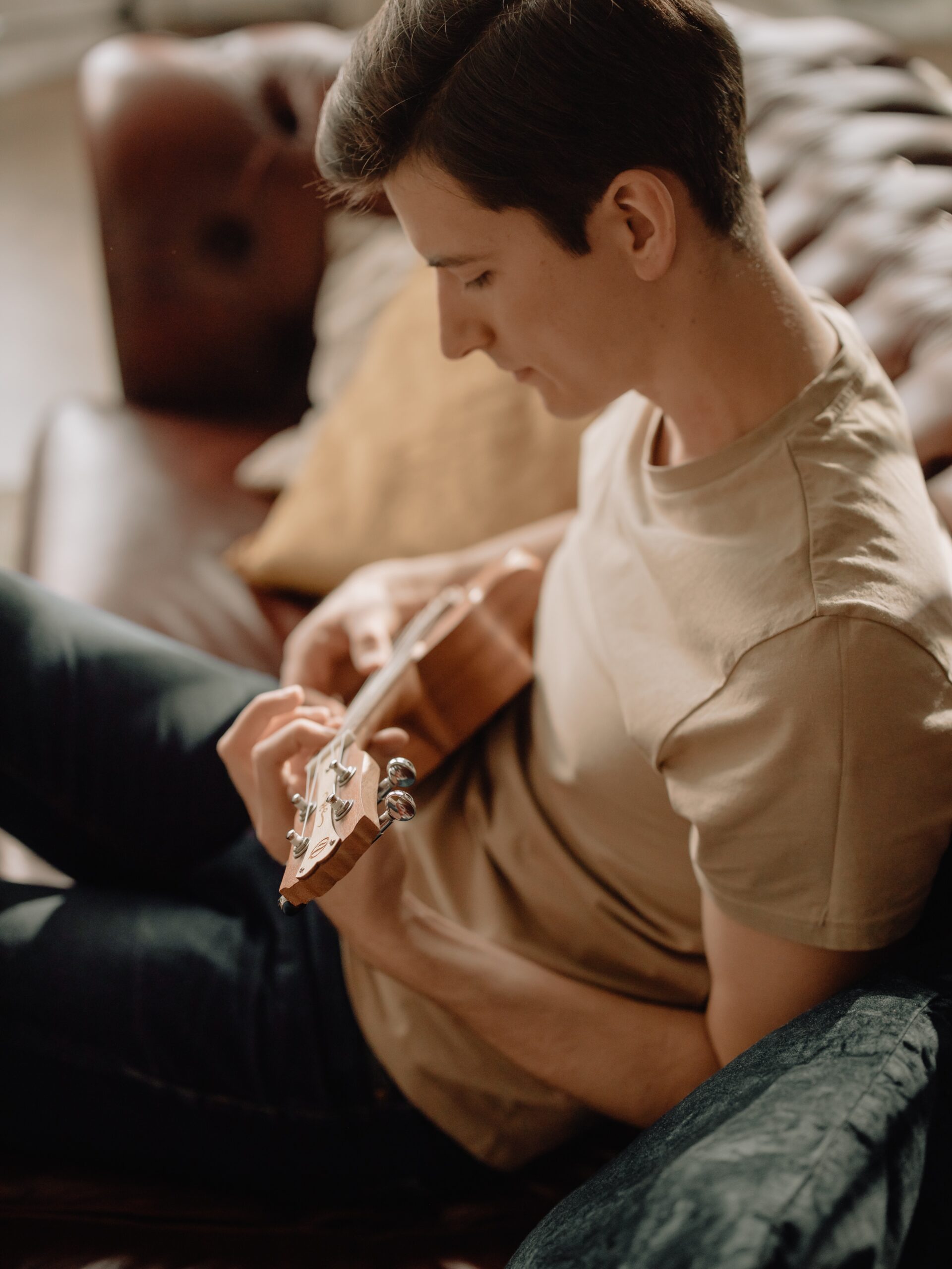 young man playing the ukulele.